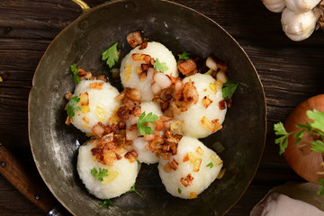 Meat stuffed potato dumplings with fried onion  and greaves on top