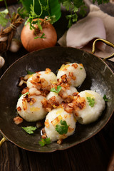 Meat stuffed potato dumplings with fried onion  and greaves on top