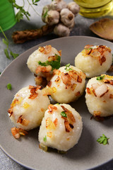 Meat stuffed potato dumplings with fried onion  and greaves on top