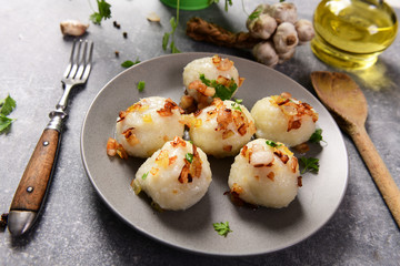 Meat stuffed potato dumplings with fried onion  and greaves on top