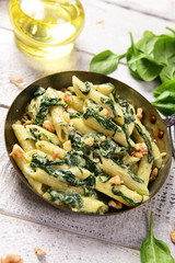 Penne pasta with spinach, gorgonzola cheese and walnuts
