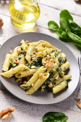 Penne pasta with spinach, gorgonzola cheese and walnuts