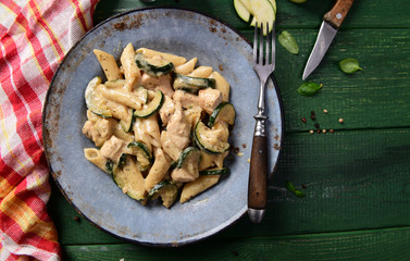 Penne pasta witch chicken and zucchini in cheese sauce