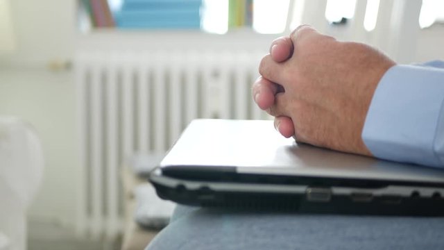 Businessman Sitting on a Meeting with Laptop on Knees Gesturing Nervous