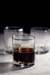 Old fashion glass of whiskey and cola on a dark background