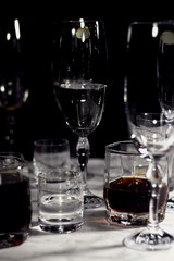Empty glasses after party on black background