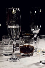 Empty glasses after party on black background