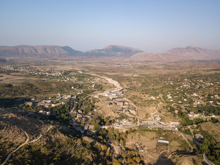 Fototapeta na wymiar Aerial view of fields, mountains and houses near Saranda, Albania. Taken from Delvina 