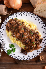 Stew with meat, mushrooms and vegetables served with groat