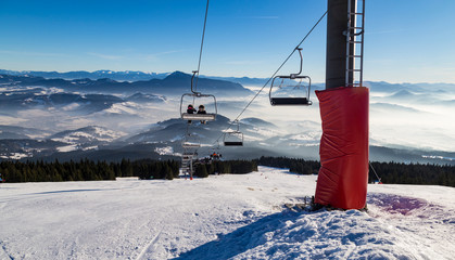 Skiers on the chairlift. Ski trails © anatoliil