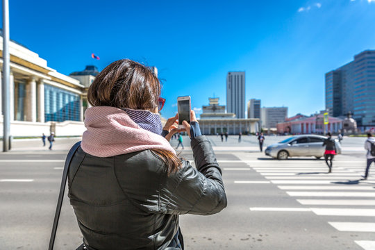 Ulaanbaatar, Mongolia - Sept 8th 2018 - A tourist taking a picture of the Sukhbaatar Square in a blue sky day in Ulaanbaatar, capital of Mongolia