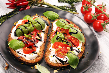 Bread with cream cheese and tomato for lunch table. Sharing antipasti on party or summer picnic...