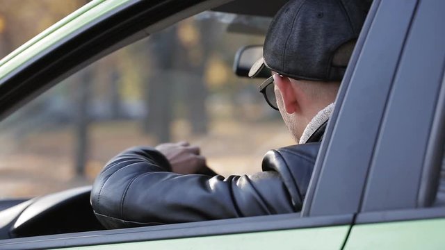 Spy is watching two women criminals from the car, taking pictures of how women exchange packages