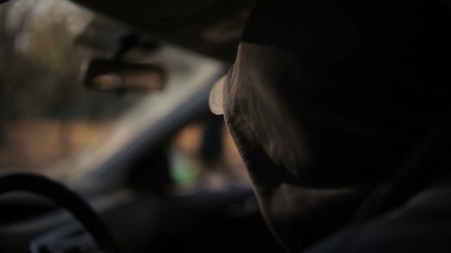 Spy is watching two women criminals from the car, taking pictures of how women exchange packages
