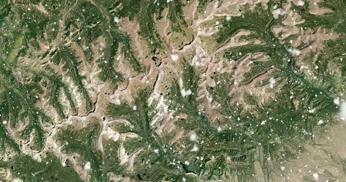 Vertical aerial ascent through heavy falling snow, over Uinta mountains, Utah. Elements of this image furnished by NASA. 