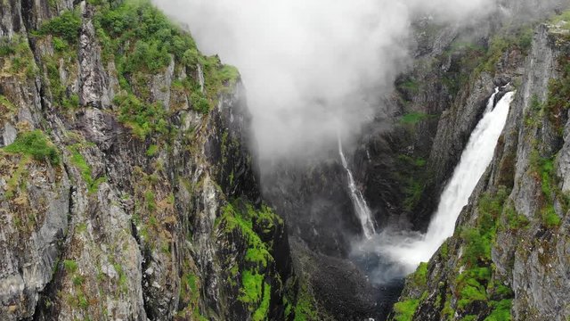 Voringsfossen waterfall, green summer mountains, Mabodalen canyon Norway. National tourist Hardangervidda route, touristroad Rv7, Eidfjord sightseeing tour