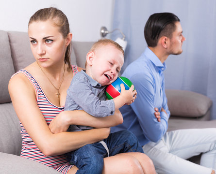 Sad male and female with child thinking about quarrel
