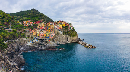 Fototapeta na wymiar beach streets and colorful houses on the hill in Manarola in Cinque Terre in Italy 