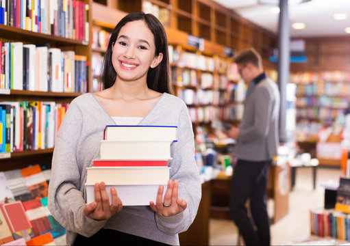  female with stack of books in hands