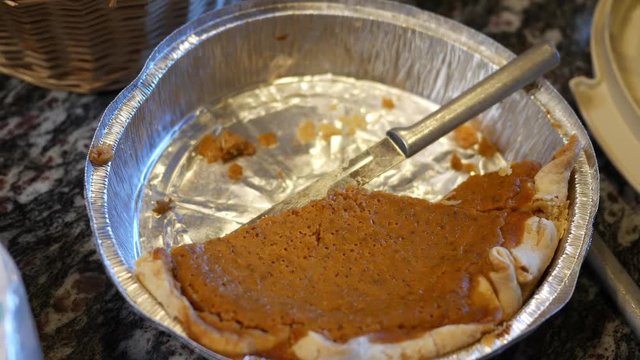 Panning to a half eaten pumpkin pie desert dish