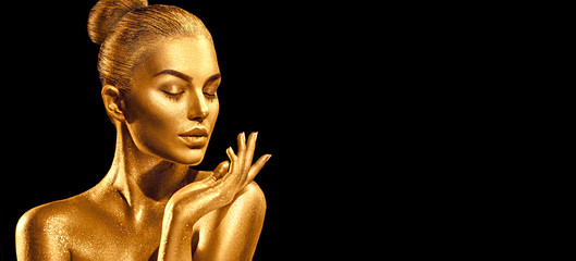 Golden skin woman portrait closeup. Sexy model girl with holiday golden shiny professional makeup. Golden metallic body