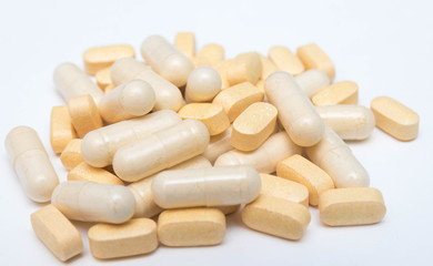 Medicine yellow pills or capsules on a white background close-up. vitamins Drug prescription of drugs for treatment. Pharmaceutical drug, cured in a container for health. Antibiotic drugs.