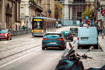Brussels, Kingdom of Belgium.  Tram and few cars on the street. Sunset. Belgian road.