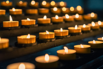 candles of fire shine in christian church as prayer