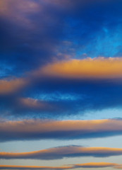 Red-blue clouds in the blue sunset sky.