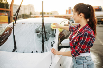 Woman on self-service car wash, carwash process