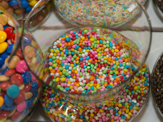 Fototapeta na wymiar Colorful Confetti Candy inside Transparent Glass Container