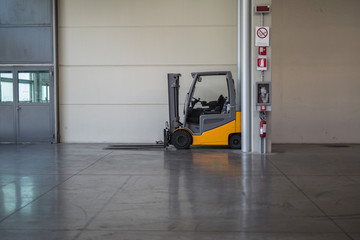 Orange Forklift Parked inside an Empty Storage Center