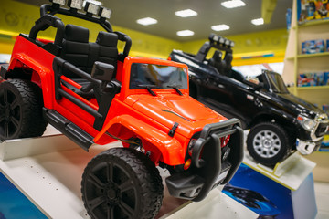Electric car on showcase in toy store, nobody