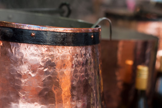 closeup of mulled wine in traditional copper cauldron at the christmas market