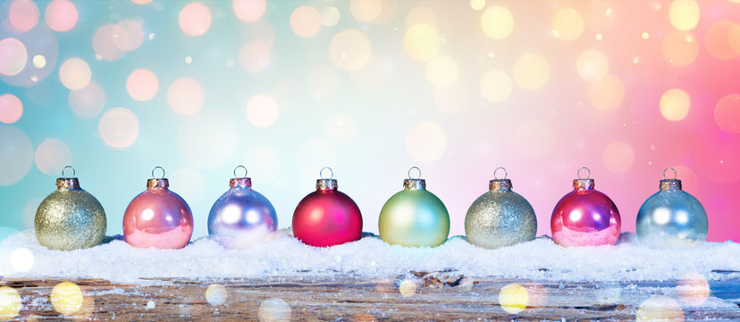 Colorful Baubles On Snow In Shiny Background
