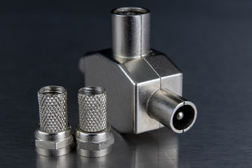 Antenna and television connectors on a metal table. Accessories for installing cable television.
