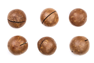 Shelled and unshelled macadamia nuts isolated on white background. Top view. Flat lay pattern. Set or collection