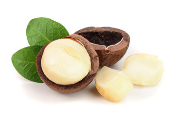 Shelled macadamia nuts with leaves isolated on white background