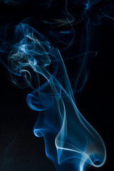 Obraz premium Blue smoke isolated on black background