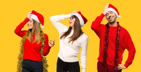 A group of people Blonde woman dressed up for christmas holidays has just realized something and has intending the solution on yellow background