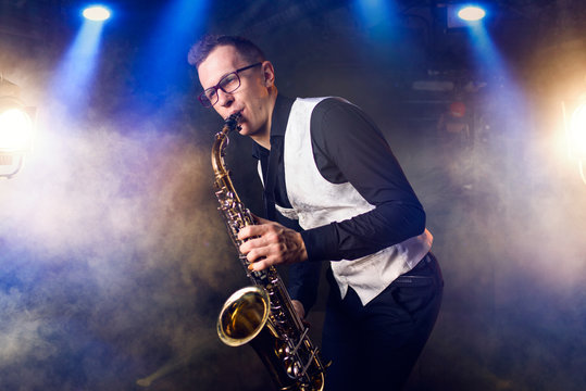 Male saxophonist playing classical music on sax