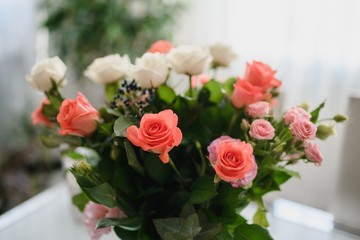 White and pink roses in a bouquet.