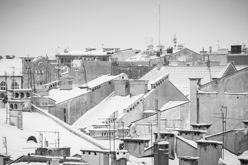 Krakow in Christmas time, aerial view on snowy roofs in central part of city. BW photo. Poland. Europe.
