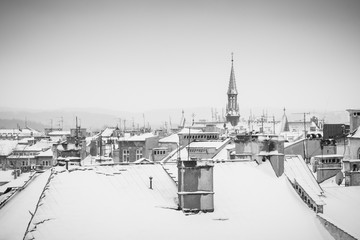 Krakow in Christmas time, aerial view on snowy roofs in central part of city. BW photo. Poland. Europe.