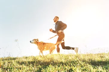 Papier Peint photo Jogging Man runs with his beagle dog. Morning Canicross exercise