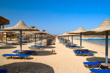 beach with chairs and umbrellas