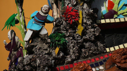 Stone relief with chinaware porcelain mosaic as religious art and decoration in a buddhist temple in downtown Taichung city, Taiwan, China, Asia