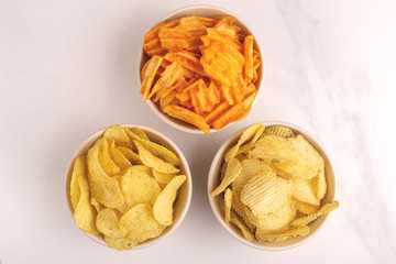 Three sorts of crispy and corrugated potato chips