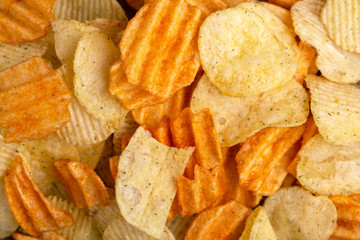 Variation of crispy and corrugated potato chips background