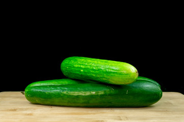 Fresh organic cucumbers on wood